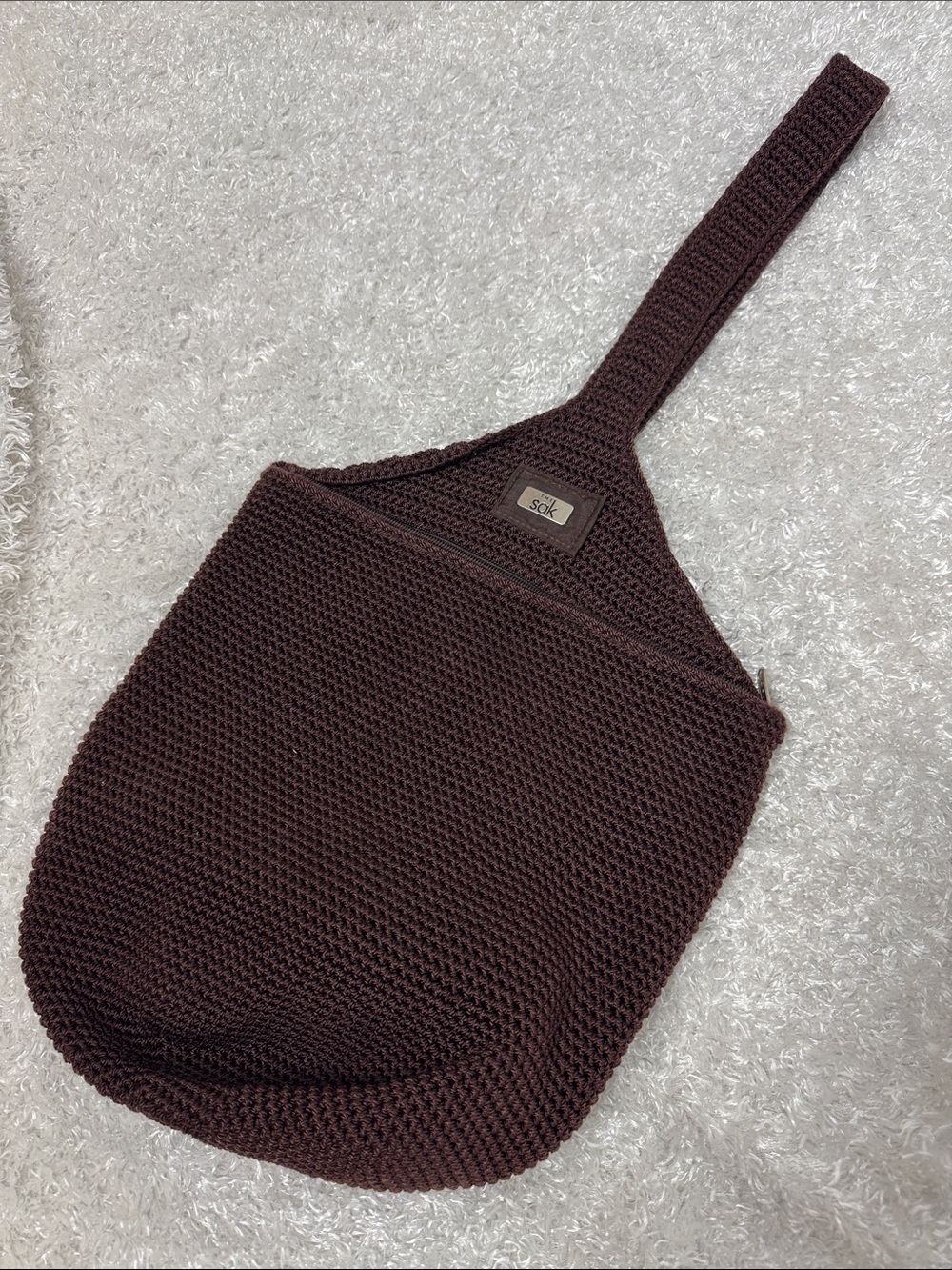 The dark brown sling bag purse